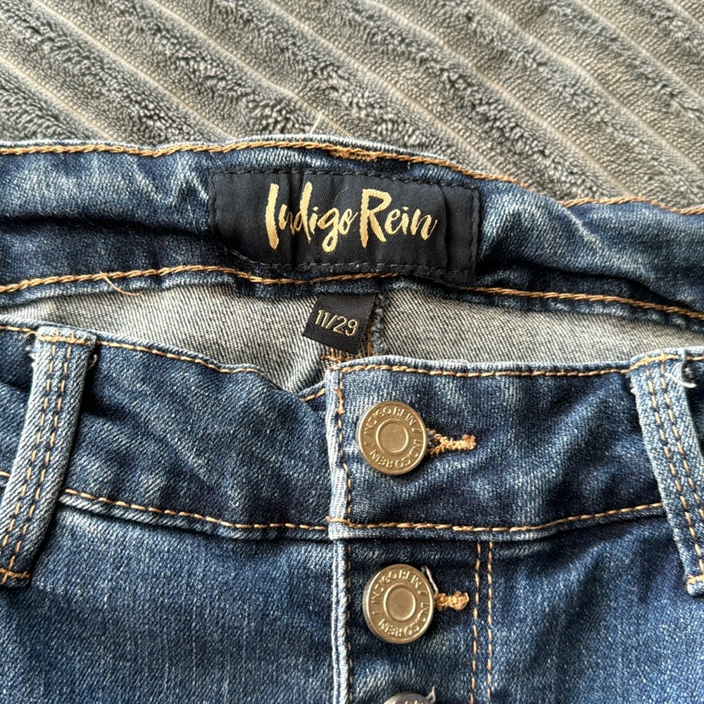 Used jeans with holes and stretch.